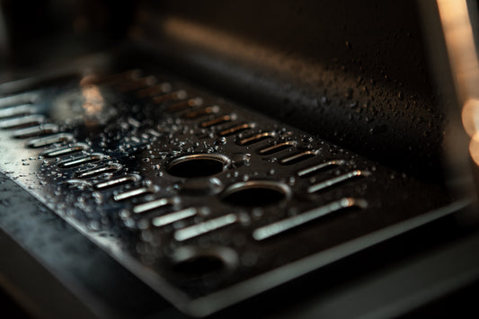 grate of espresso machine with water drops